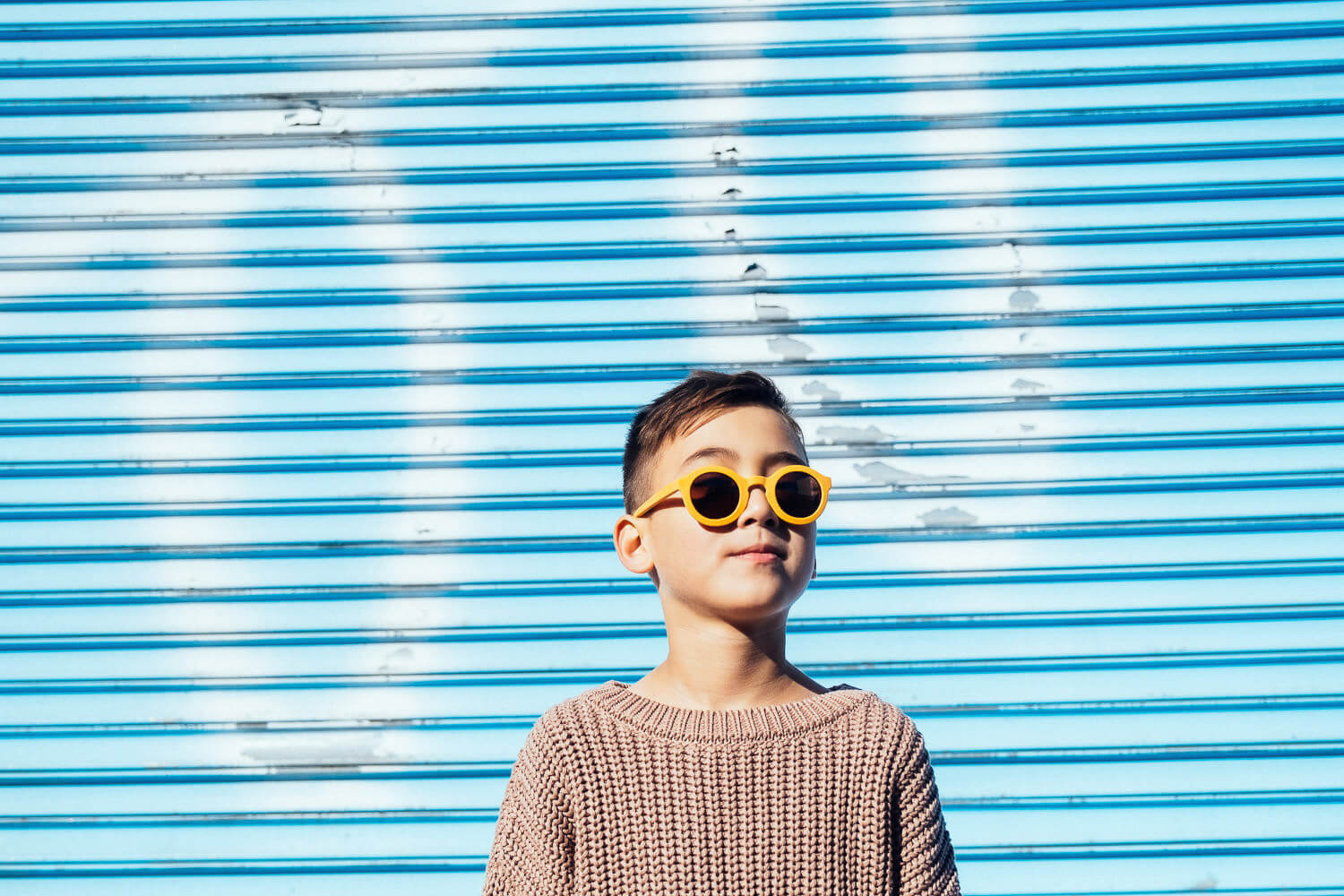 Portrait of a 7 years old wearing cool looking sun glasses