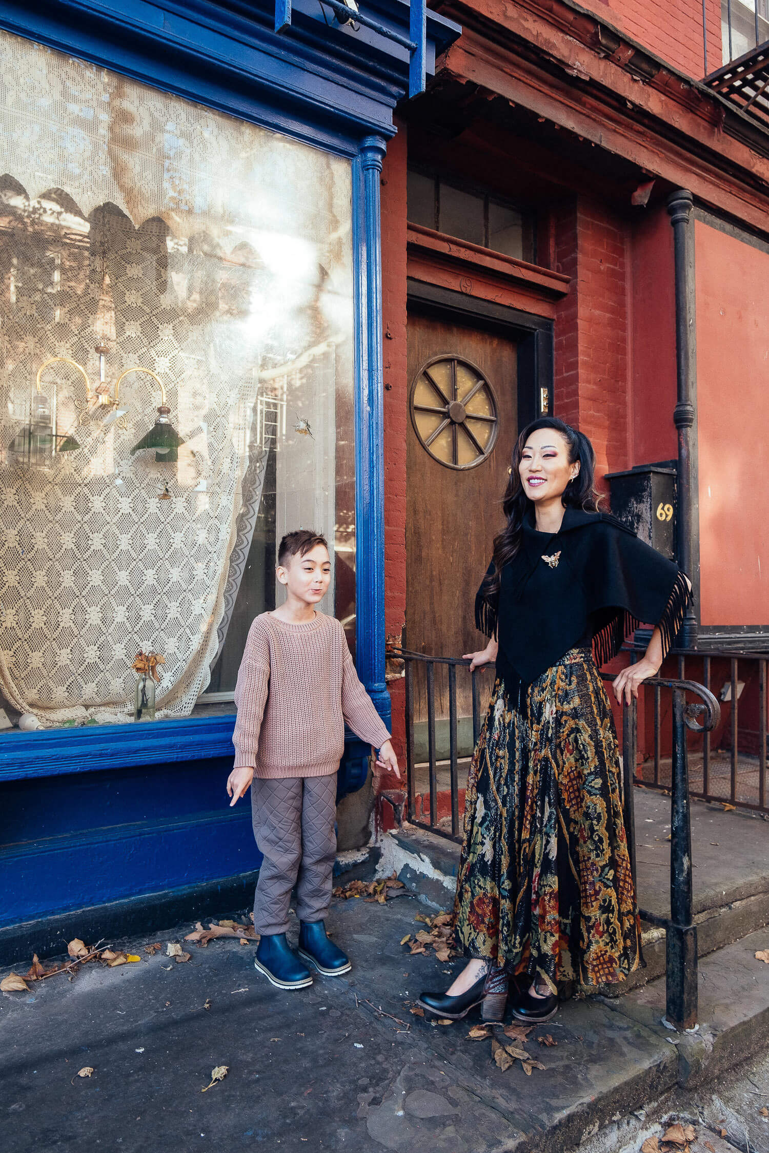 Mom and son having a great time in Vinegar Hill, in Dumbo Brooklyn. They are wearing fall outfits and having their holiday family pictures taken. 