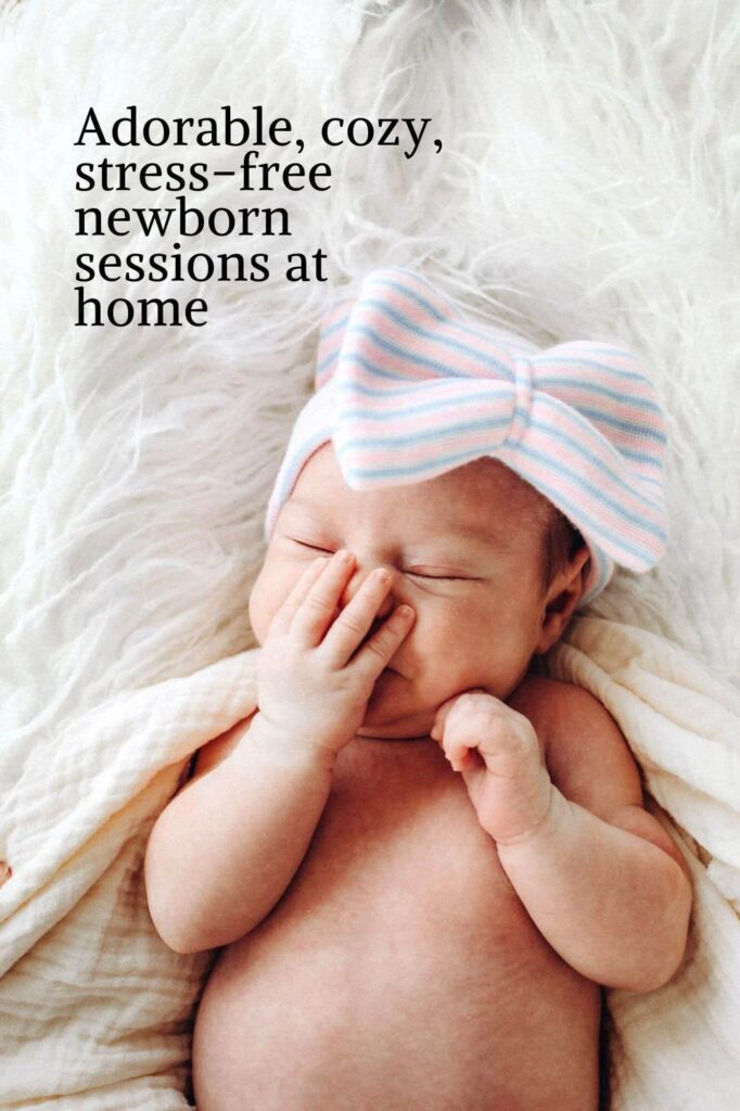 A sleeping baby wearing a large striped bow headband lies on a white, fluffy surface. The baby gently touches their face with one hand. Text on the photograph reads, Adorable, cozy, stress-free newborn sessions at home—perfect for families seeking creative session ideas.