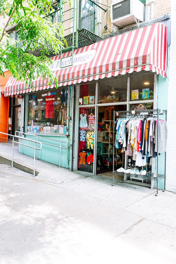 Jane's Exchange children and maternity consignment store exterior with red and white striped awning East Village New York City