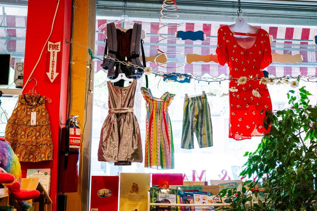 Vintage and pre-loved maternity dresses hanging in the window at Janes Exchange consignment boutique East Village New York City