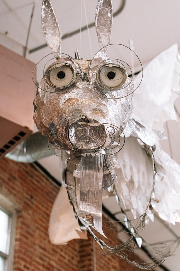 Handmade silver foil rabbit sculpture hanging from ceiling at Mini Jake kids store Brooklyn New York City